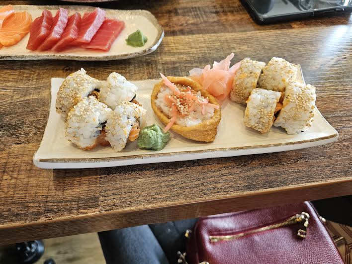 sushi pieces on a long white plate
