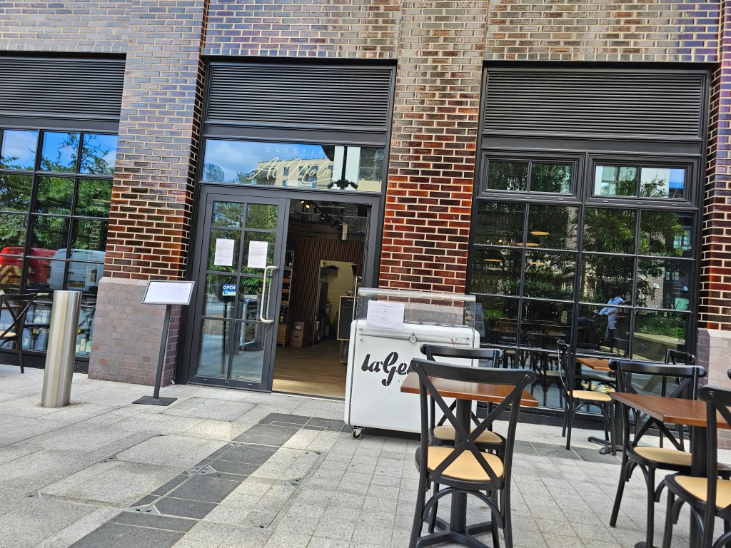 restaurant front door with 'Osteria Al Modo', level access and an ice cream trolley. There are also outdoor tables